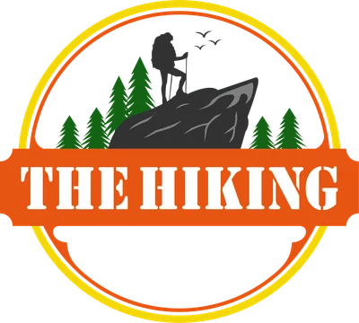 Hình ảnh logo người leo núi đứng trên đỉnh đá, có cây thông và chim bay, chữ 'THE HIKING'